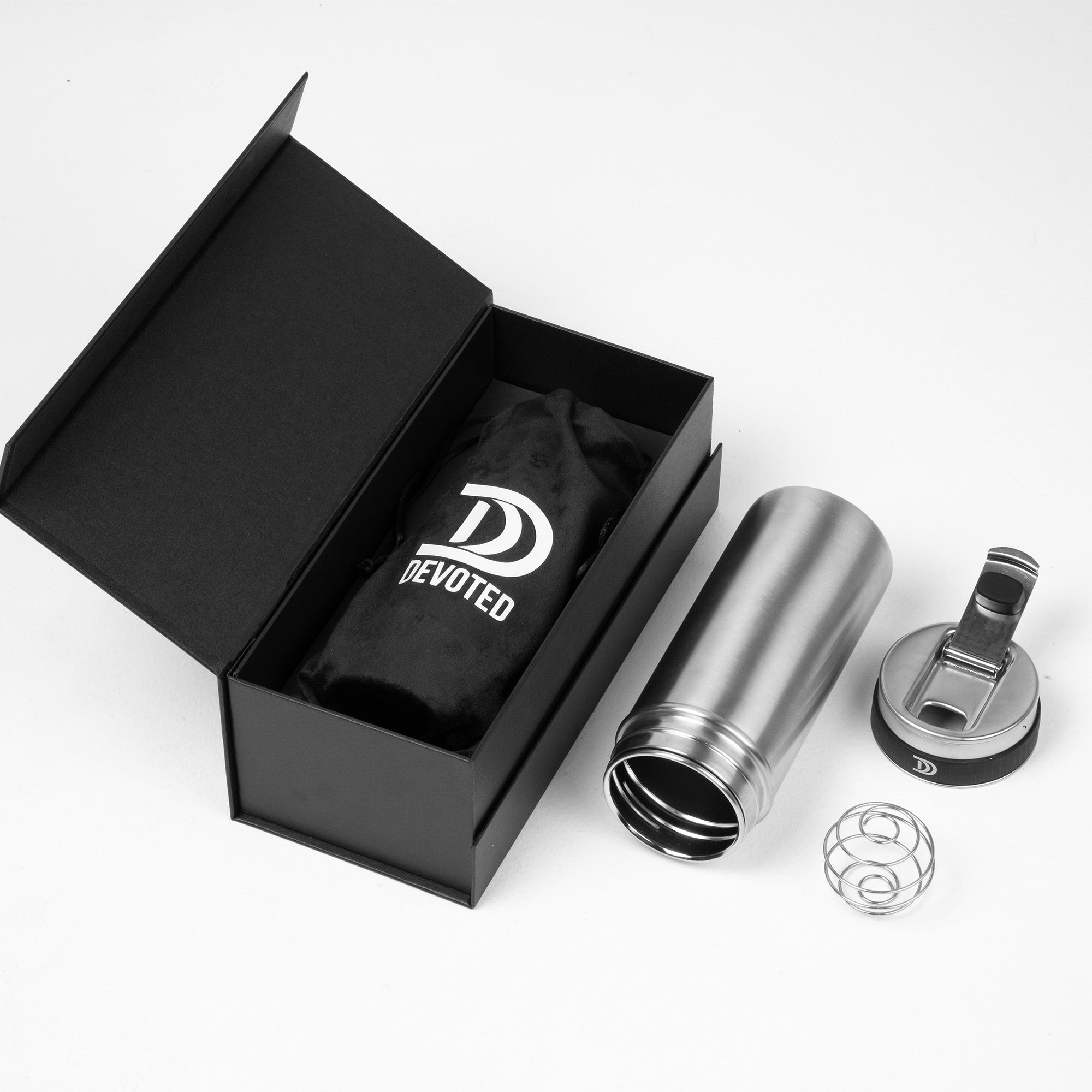 Devoted Steel Shaker disassembled silver stainless steel tumbler with lid, whisk ball, and premium black logo box on a white background