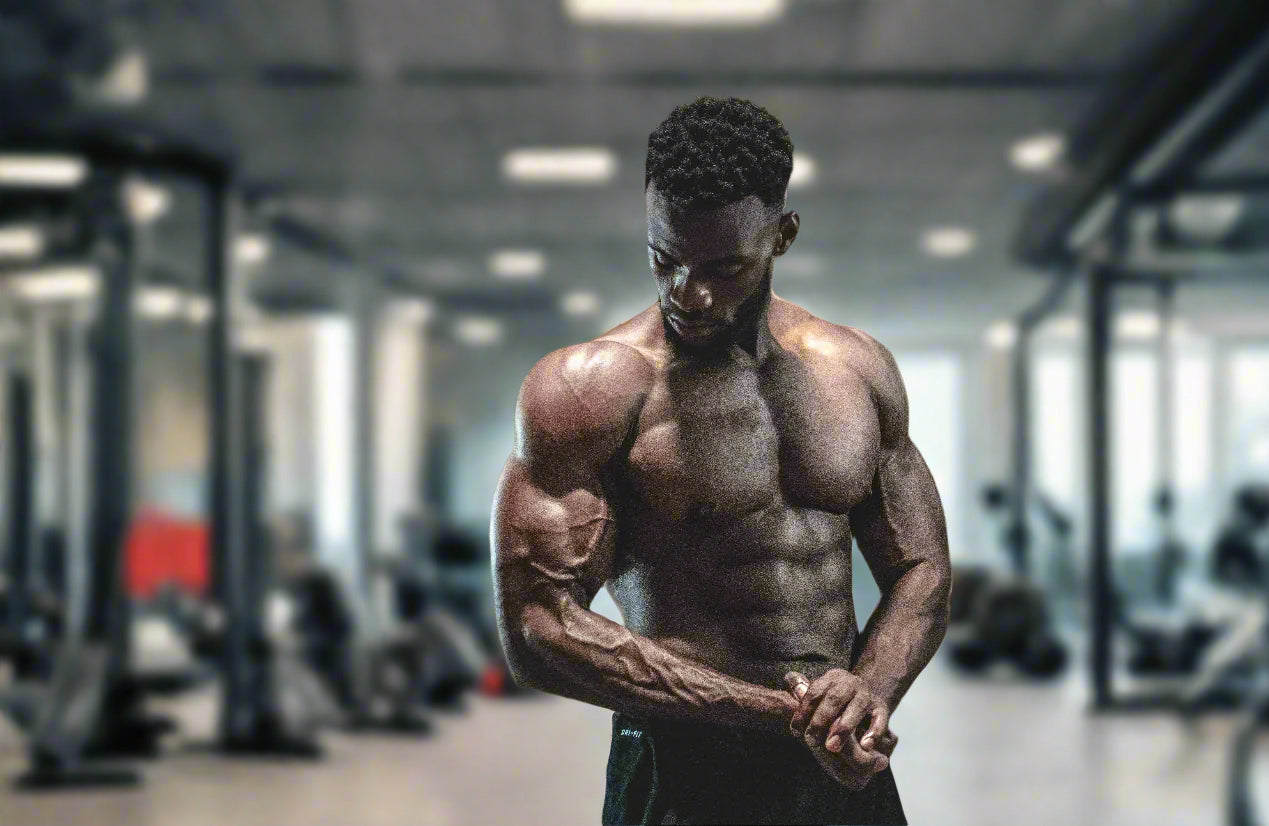 bodybuilder man posing in dimly lit gym 